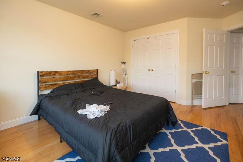 307 Pearl Street Elizabeth, NJ 07202 - Photo 11 of 13 a bed sitting in a bedroom next to a cabinet