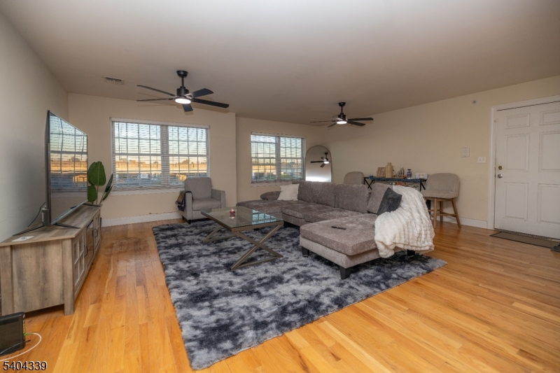 307 Pearl Street Elizabeth, NJ 07202 - Photo 2 of 13 a living room with furniture and a flat screen tv