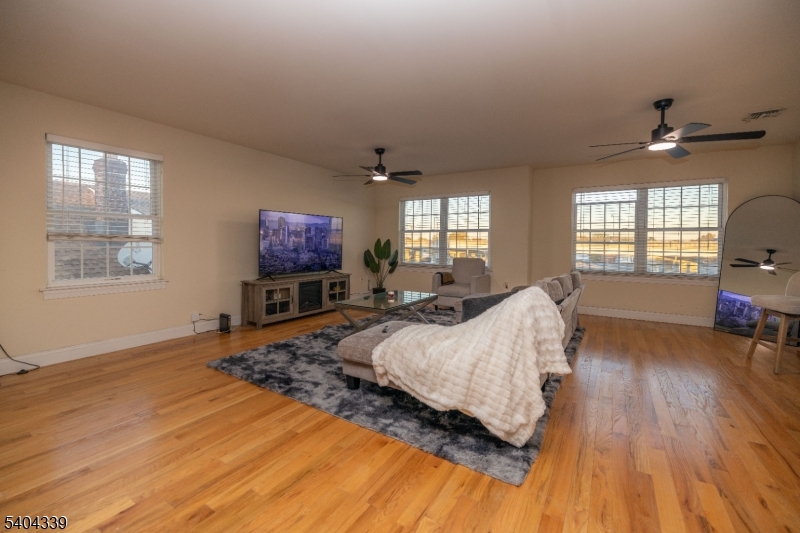 307 Pearl Street Elizabeth, NJ 07202 - Photo 3 of 13 a spacious bedroom with a bed and wooden floor