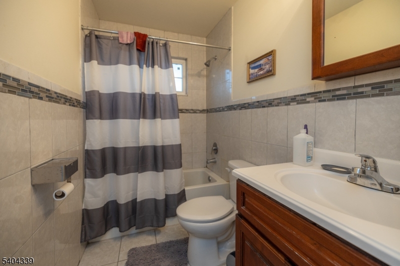 307 Pearl Street Elizabeth, NJ 07202 - Photo 7 of 13 a bathroom with a sink a toilet and shower