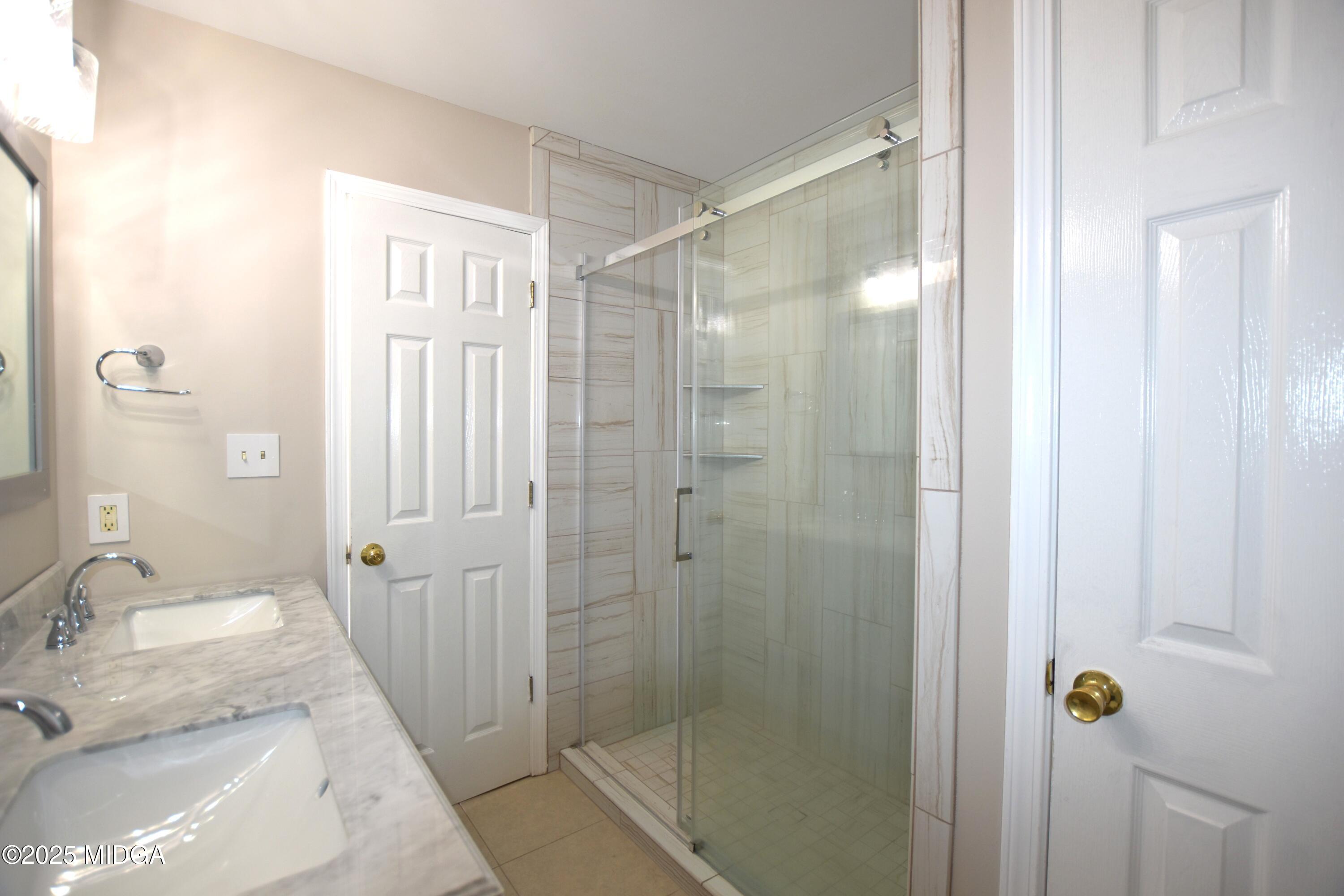 6550 Skipper Road Macon, GA 31216 - Photo 12 of 35 a bathroom with a granite countertop shower sink vanity and mirror