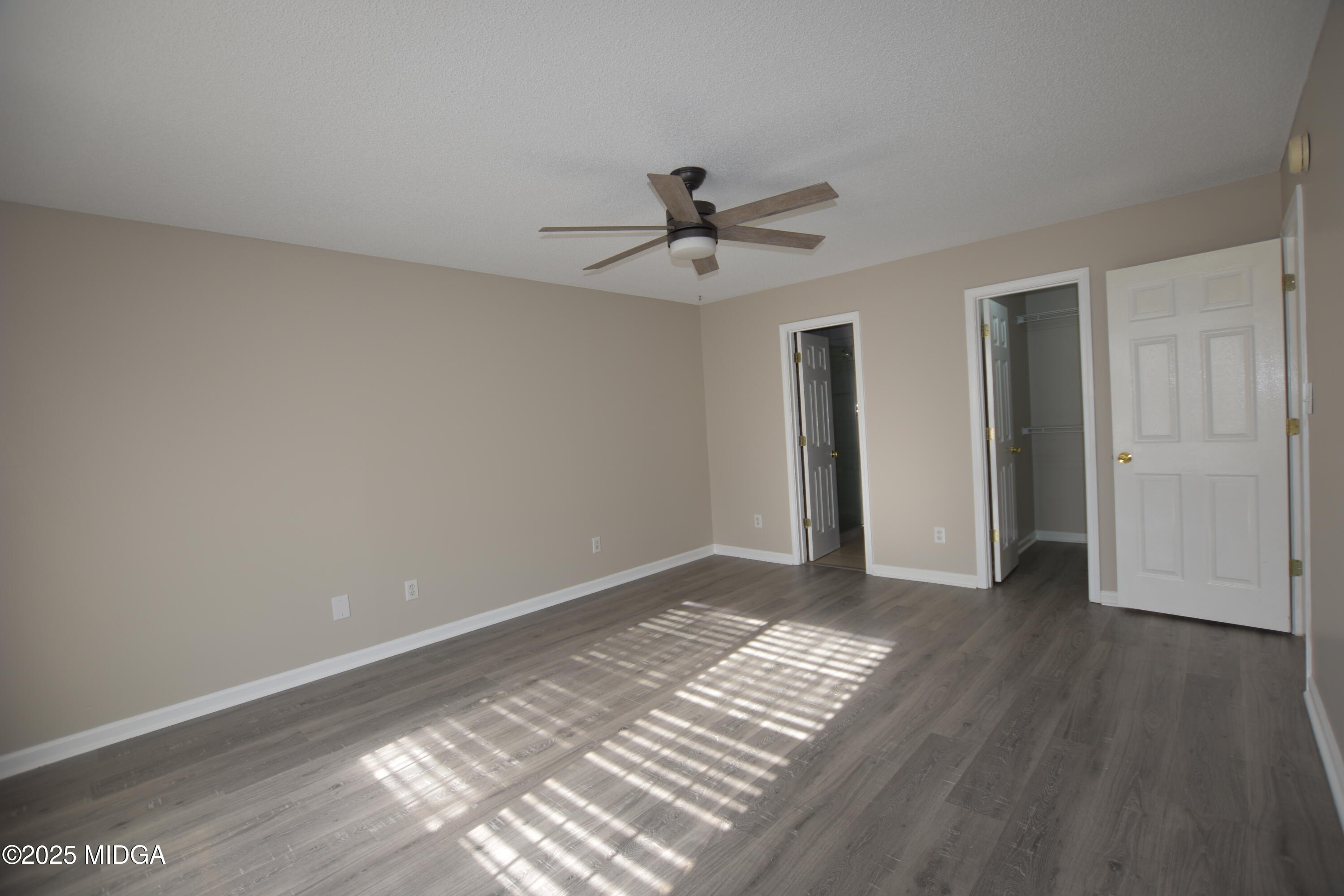 6550 Skipper Road Macon, GA 31216 - Photo 14 of 35 a view of an empty room with wooden floor and a ceiling fan