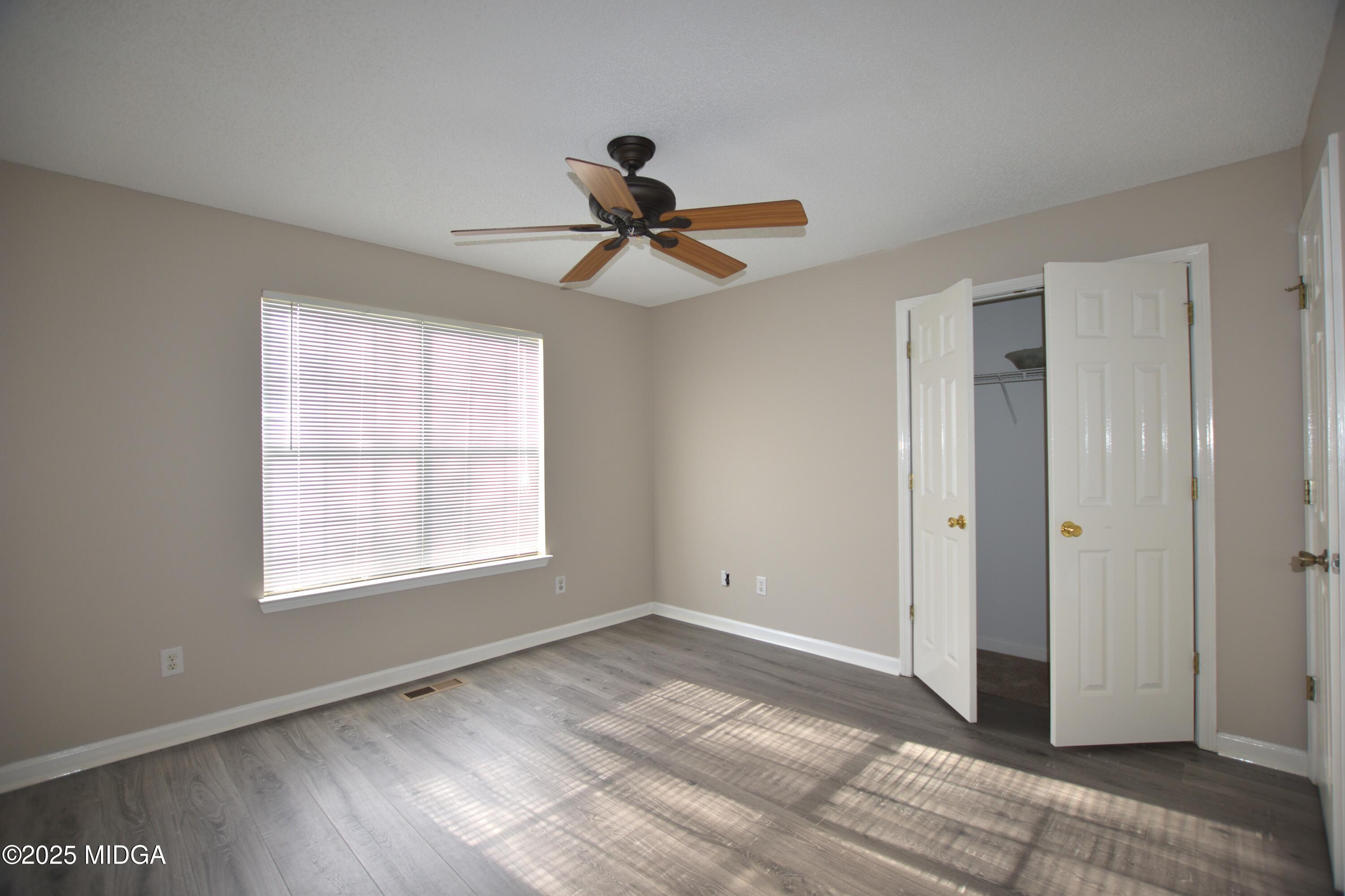 6550 Skipper Road Macon, GA 31216 - Photo 15 of 35 a view of an empty room and window and a ceiling fan
