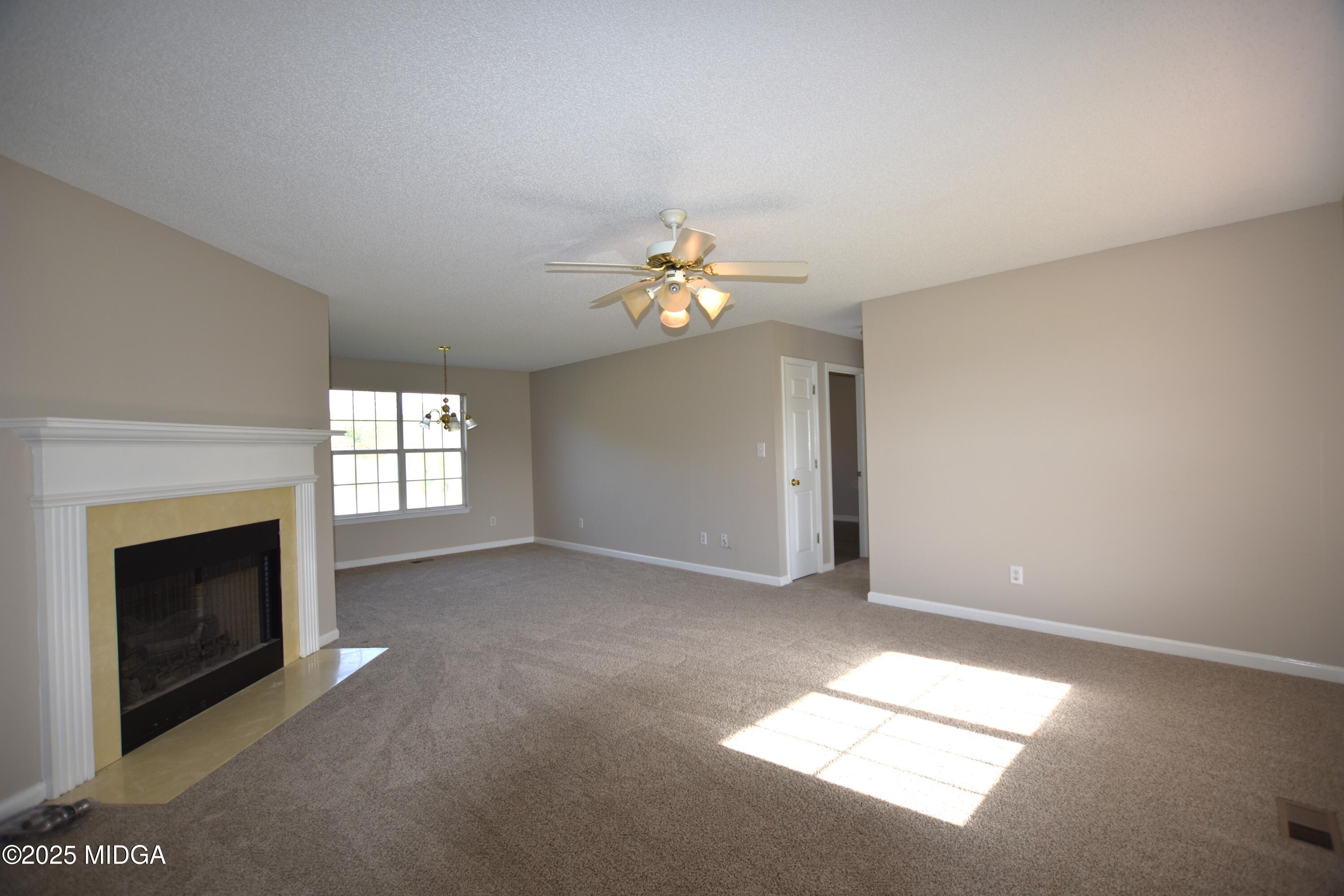 6550 Skipper Road Macon, GA 31216 - Photo 20 of 35 an empty room with windows and fireplace