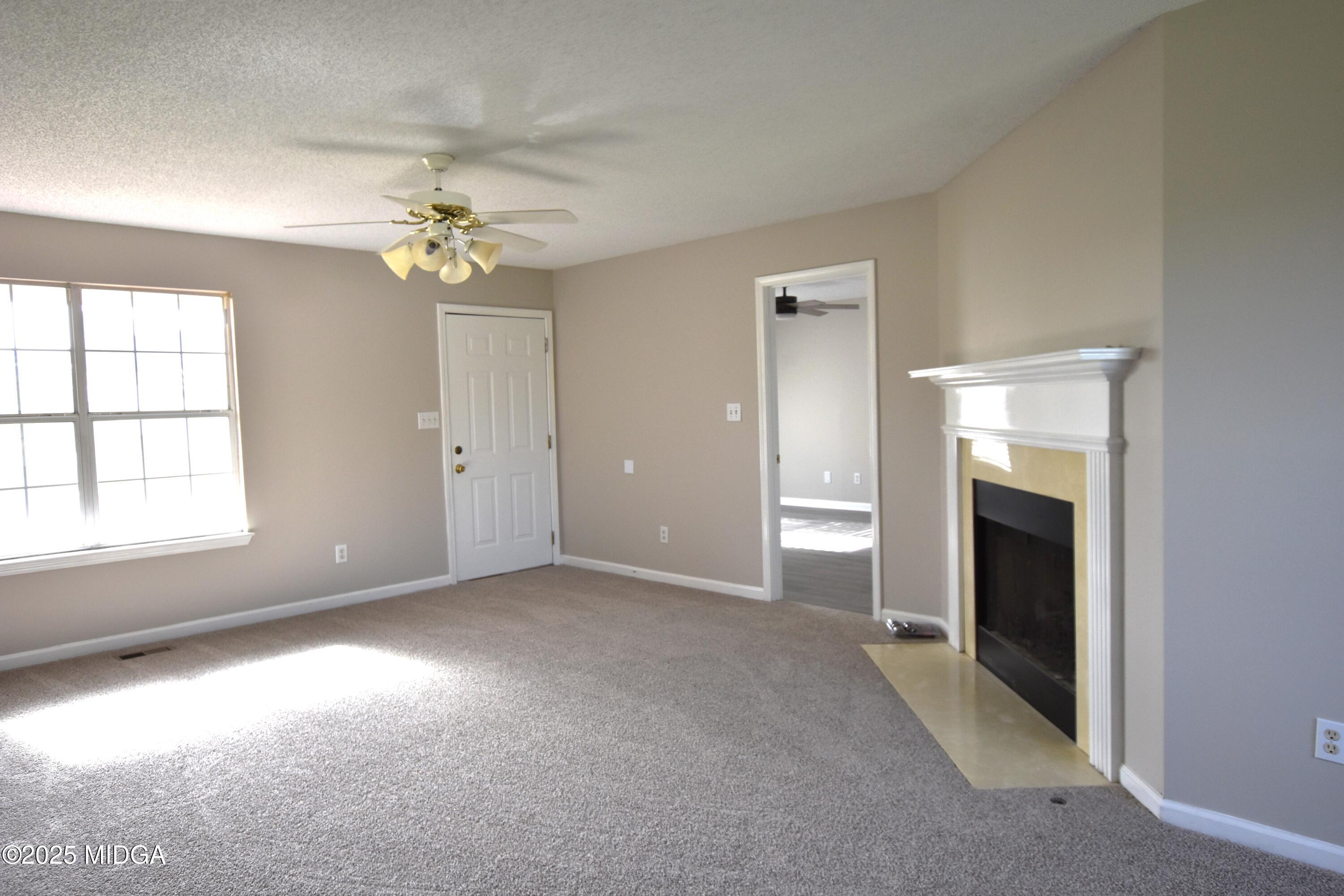 6550 Skipper Road Macon, GA 31216 - Photo 27 of 35 wooden floor in an empty room with a window