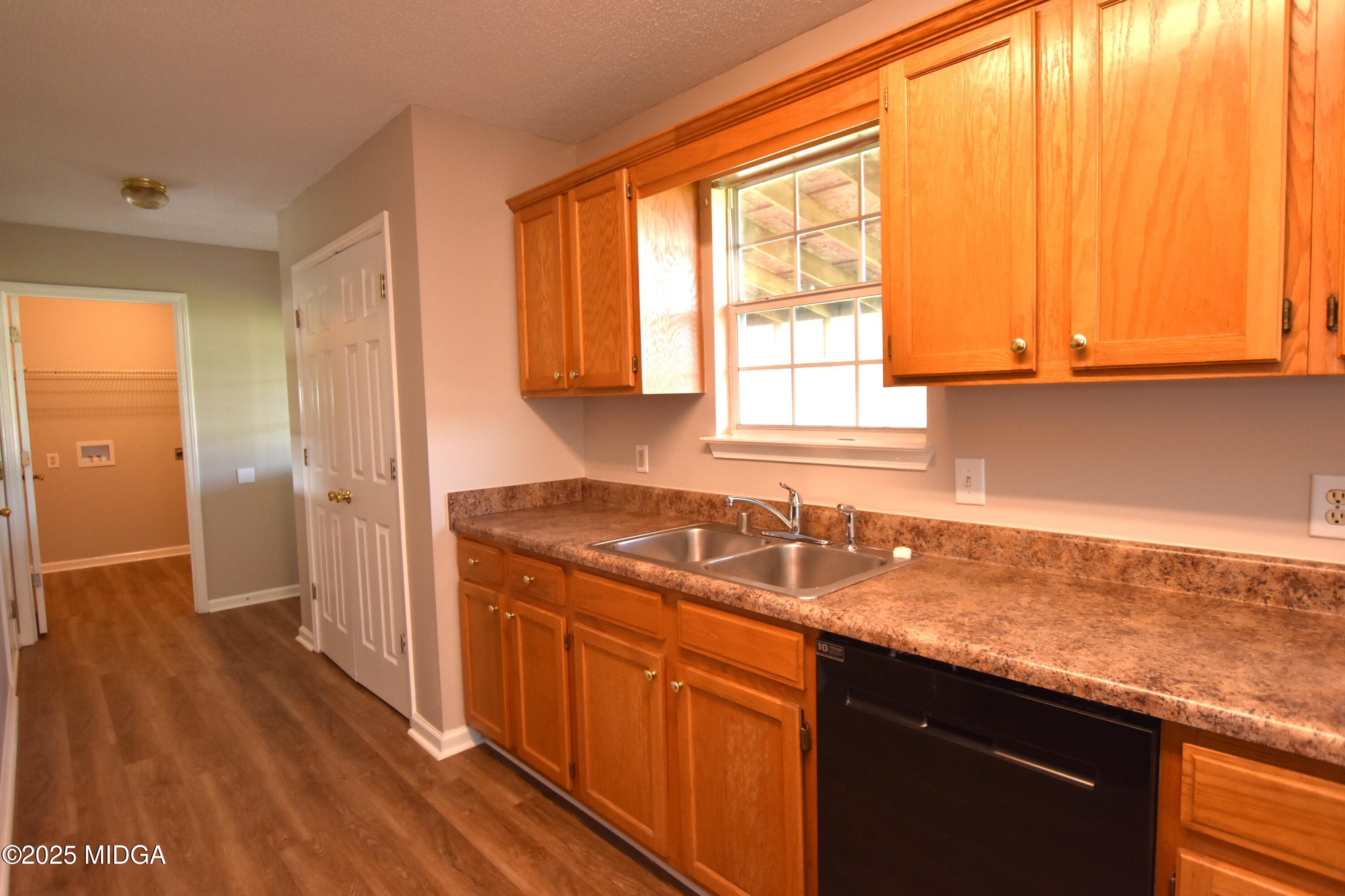 6550 Skipper Road Macon, GA 31216 - Photo 30 of 35 a kitchen with a sink a window and appliances