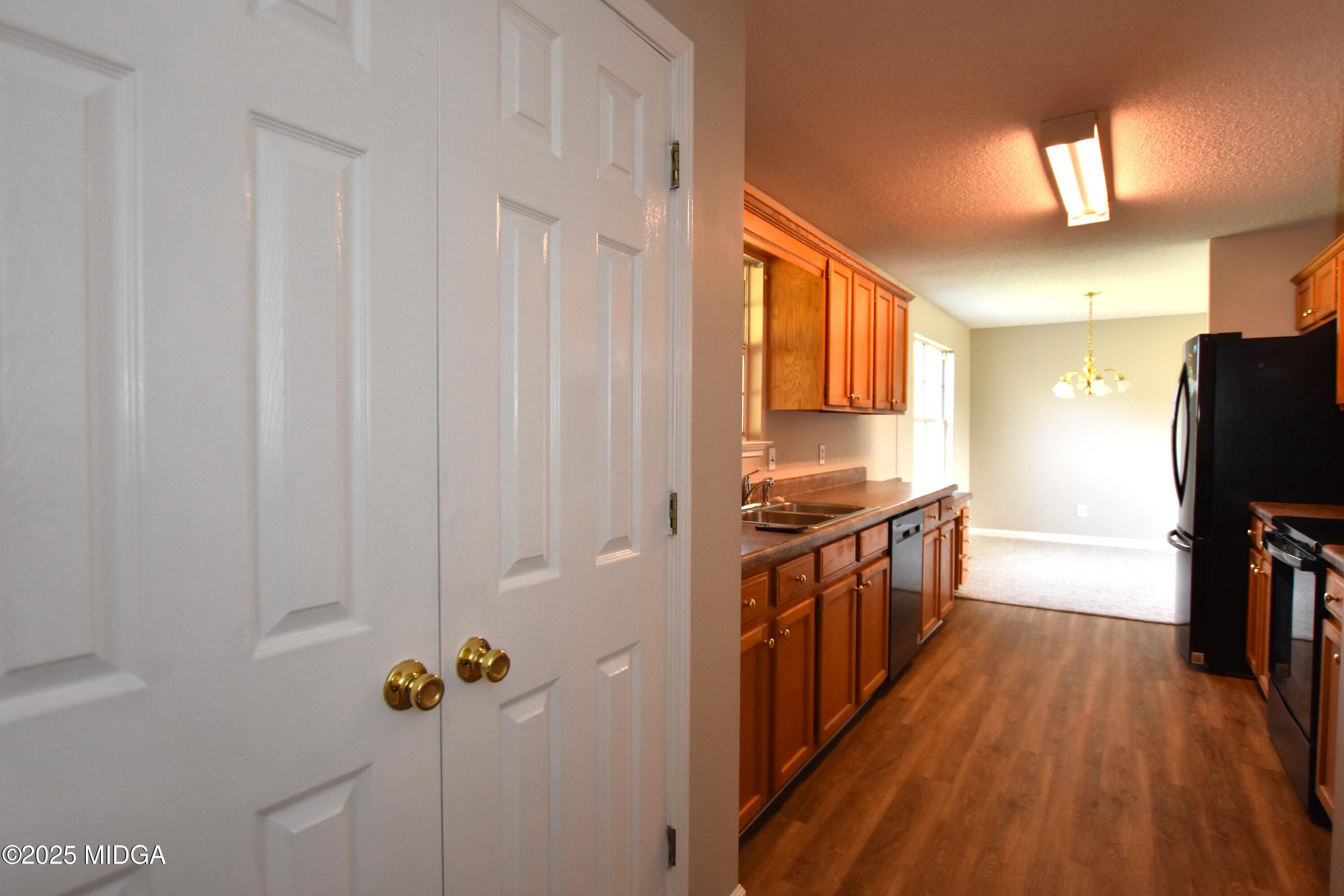 6550 Skipper Road Macon, GA 31216 - Photo 32 of 35 a kitchen with stainless steel appliances granite countertop a refrigerator a stove and a wooden floors