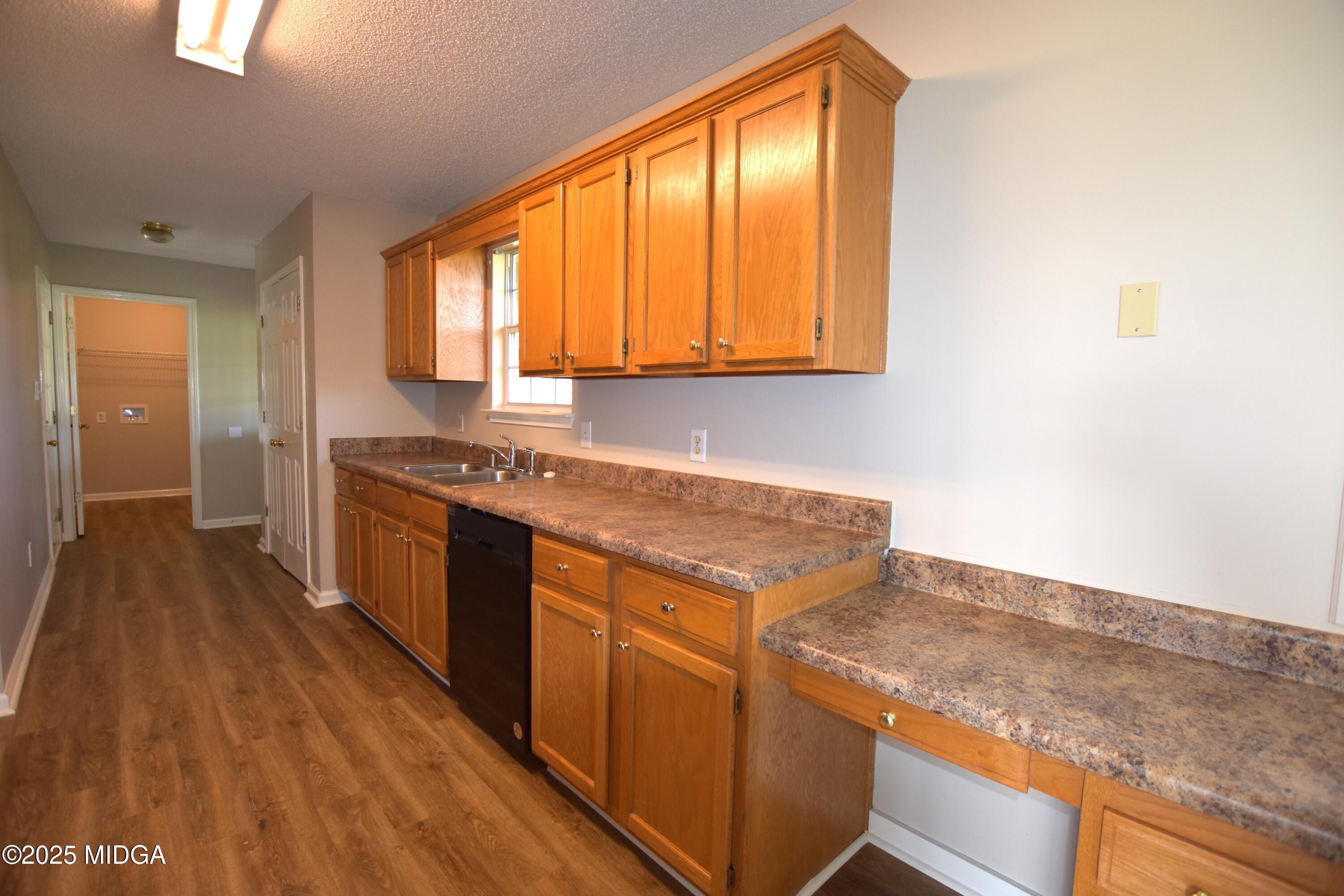 6550 Skipper Road Macon, GA 31216 - Photo 10 of 35 a kitchen with granite countertop cabinets stainless steel appliances a sink and a large window