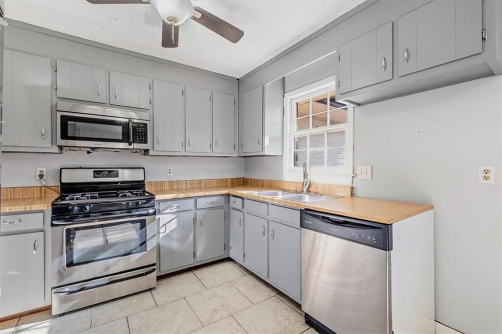 95 Cash Town Road Aragon, GA 30104 - Photo 5 of 22 a kitchen with granite countertop a sink stainless steel appliances and cabinets