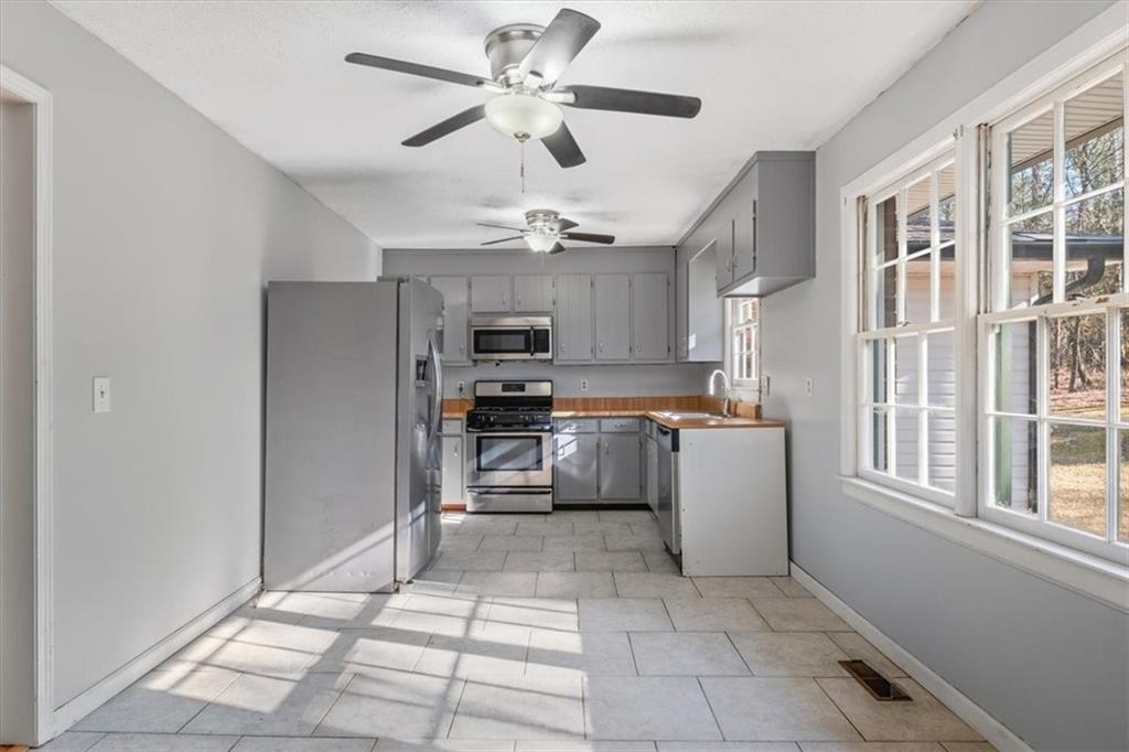 95 Cash Town Road Aragon, GA 30104 - Photo 6 of 22 a kitchen with granite countertop a refrigerator a sink cabinets and stainless steel appliances