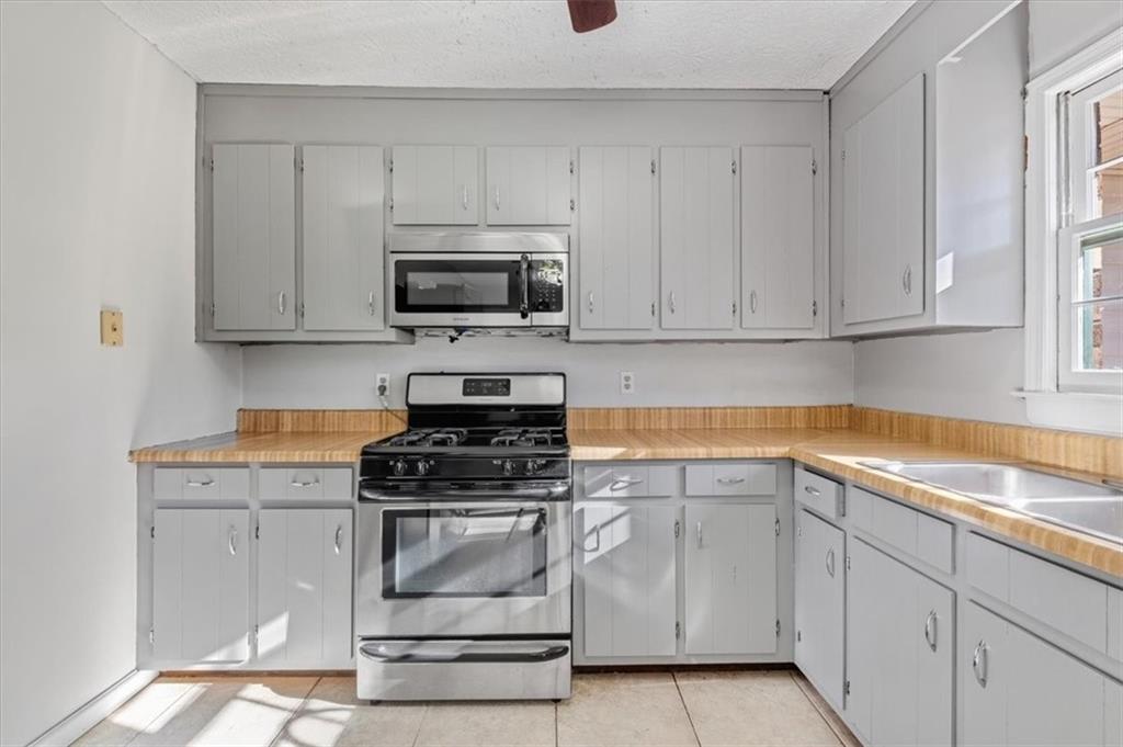 95 Cash Town Road Aragon, GA 30104 - Photo 7 of 22 a kitchen with white cabinets and appliances