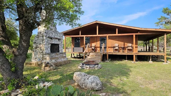 a view of a house with backyard porch and sitting area