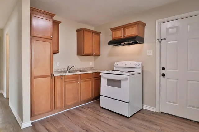 a kitchen with white cabinets and white appliances