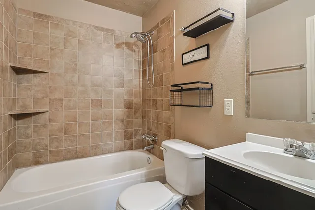 a bathroom with a sink toilet and shower