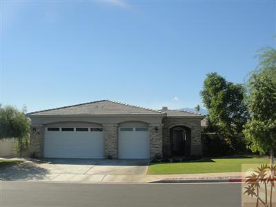 13 Napoleon Road Rancho Mirage, CA 92270 - Photo 1 of 23 a front view of a house with yard and garage