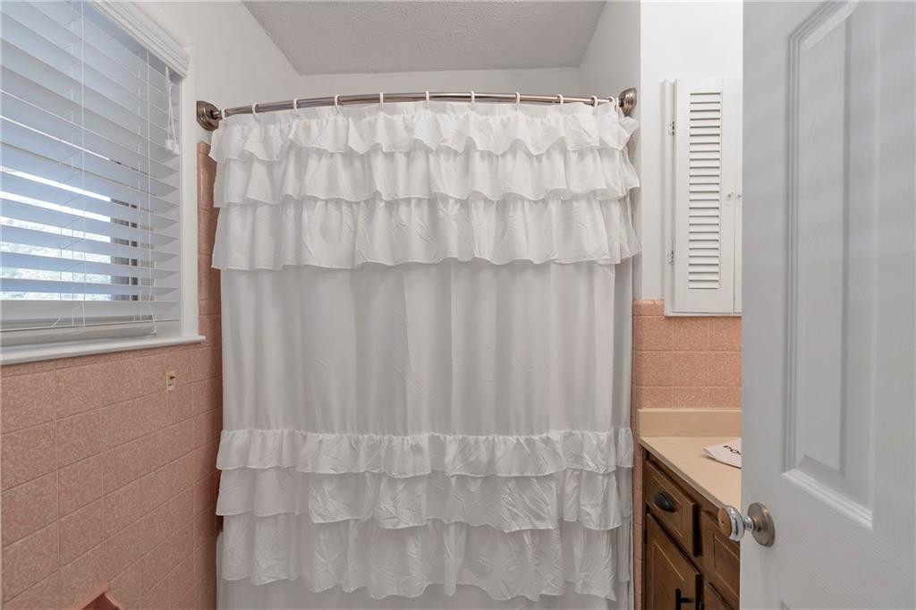 2037 Pinetree Trail Gainesville, GA 30501 - Photo 19 of 35 a bathroom with a shower curtain and a window