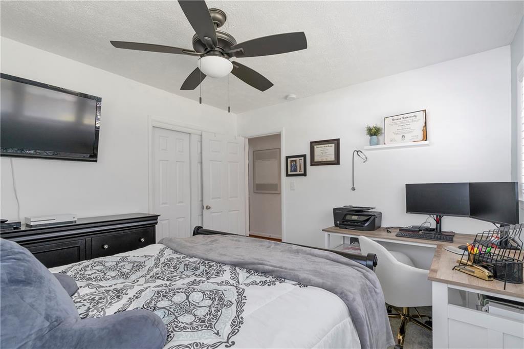 2037 Pinetree Trail Gainesville, GA 30501 - Photo 22 of 35 a bedroom with a bed and a flat screen tv