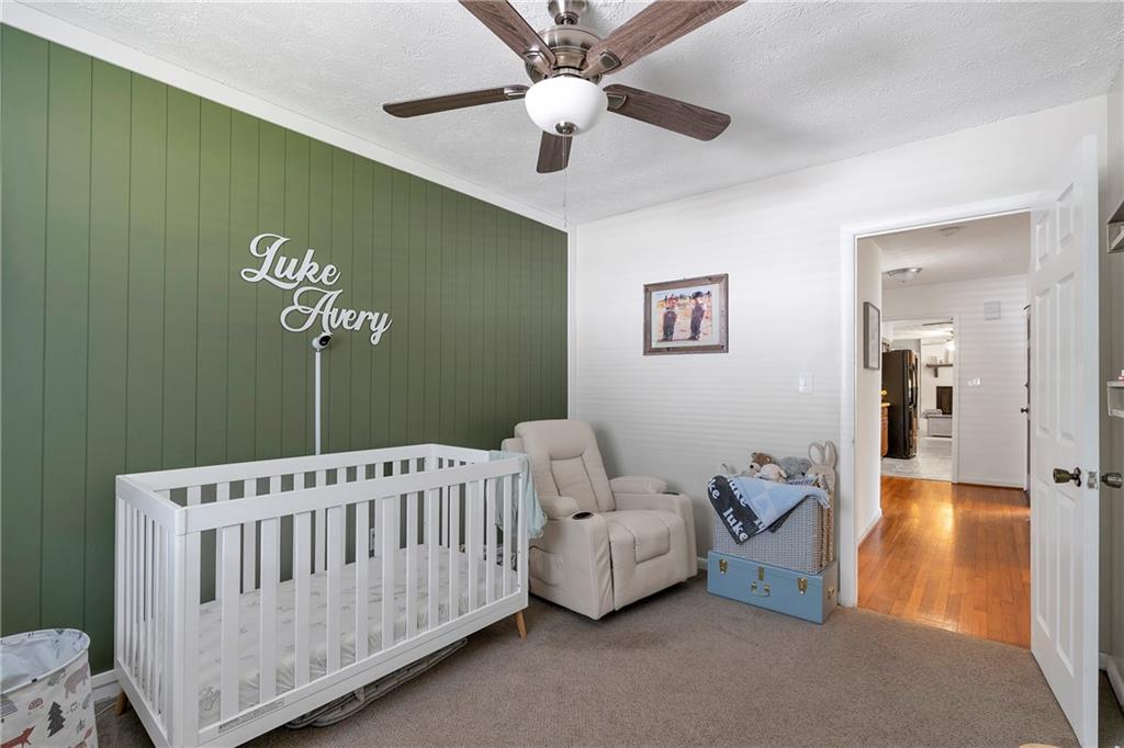 2037 Pinetree Trail Gainesville, GA 30501 - Photo 24 of 35 a bedroom with a bed and a chandelier