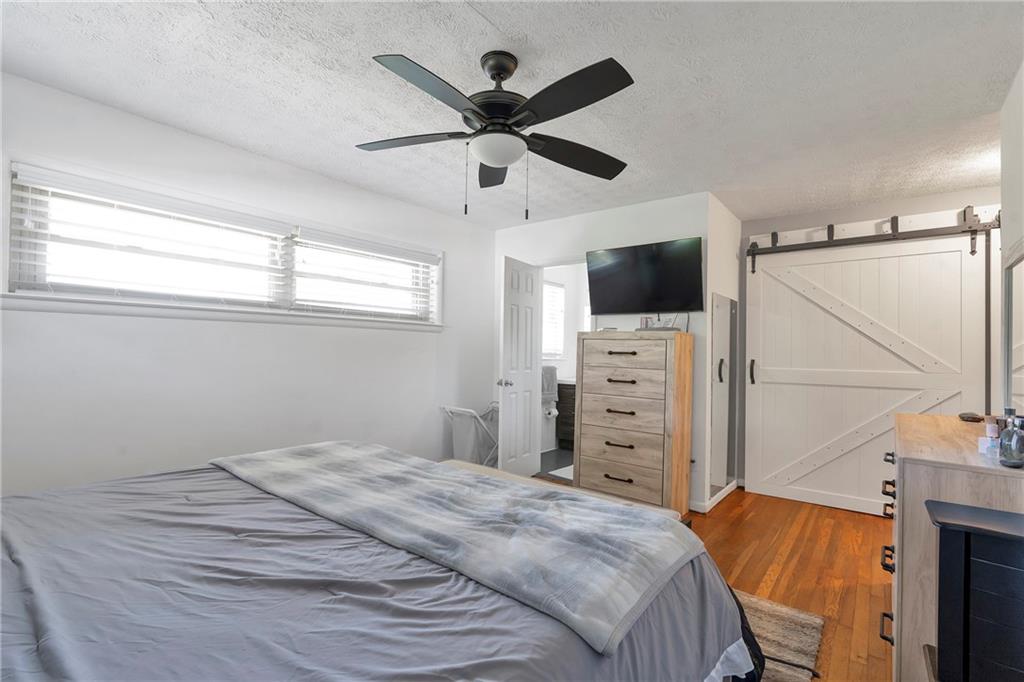 2037 Pinetree Trail Gainesville, GA 30501 - Photo 26 of 35 a bedroom with a bed and a flat tv screen