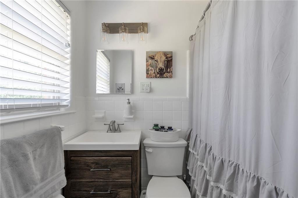 2037 Pinetree Trail Gainesville, GA 30501 - Photo 28 of 35 a bathroom with a toilet sink and mirror