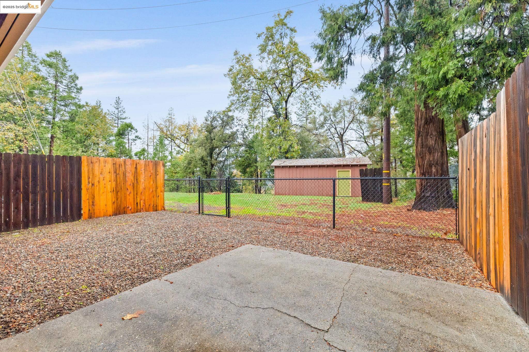 17943 Plateau Road Sonora, CA 95370 - Photo 9 of 11 Fenced backyard with a patio and a gate