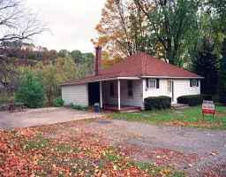 319 Decker Ferry Road Mount Bethel, PA 18343 - Photo 1 of 1 a front view of a house with a yard and garage