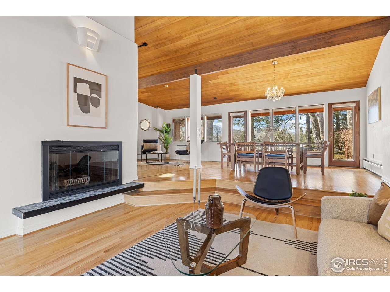 1193 Old Tale Road Boulder, CO 80303 - Photo 15 of 50 a living room with furniture a fireplace and a floor to ceiling window