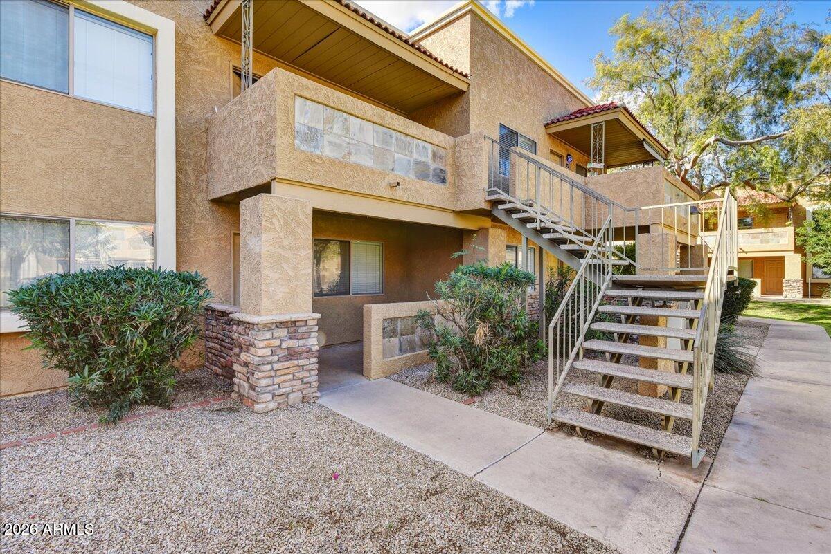 303 North Miller Road, Unit 2002 Scottsdale, AZ 85257 - Photo 2 of 12 front view of a house with a yard