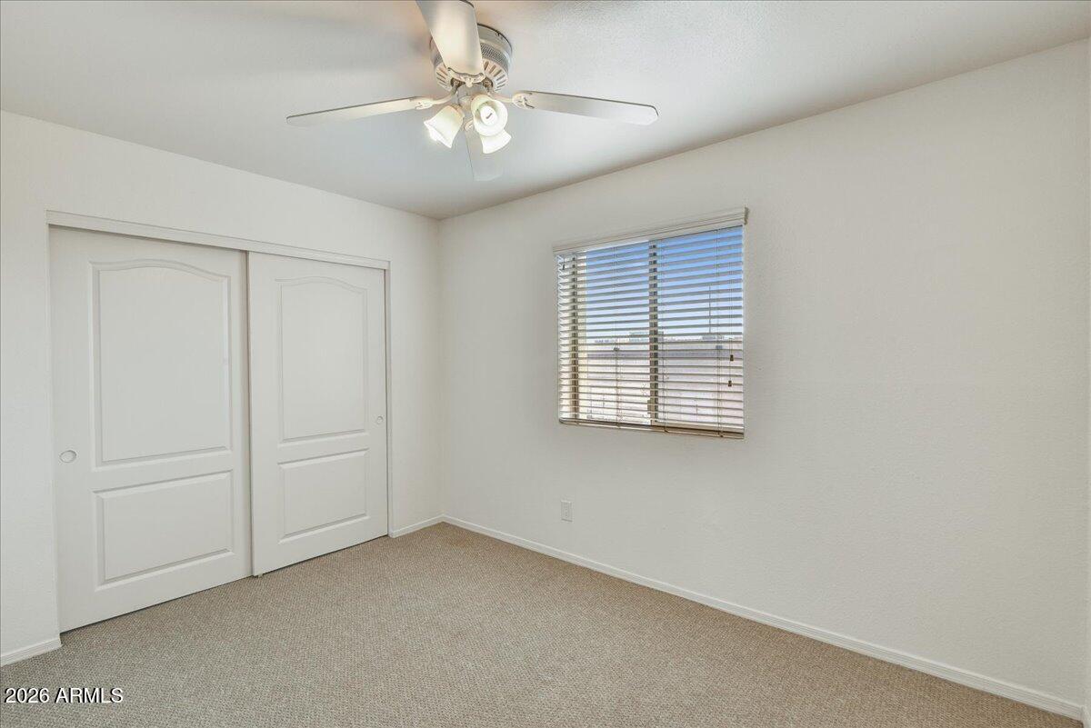 303 North Miller Road, Unit 2002 Scottsdale, AZ 85257 - Photo 9 of 12 an empty room with windows and fan