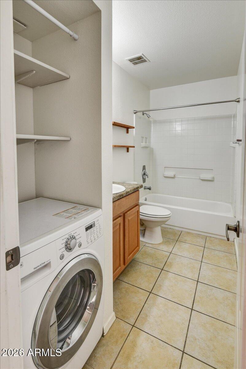 303 North Miller Road, Unit 2002 Scottsdale, AZ 85257 - Photo 10 of 12 a view of a storage & utility room with washer and dryer