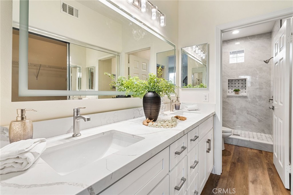 61 Stepping Stone Irvine, CA 92603 - Photo 16 of 24 a bathroom with a sink and a mirror