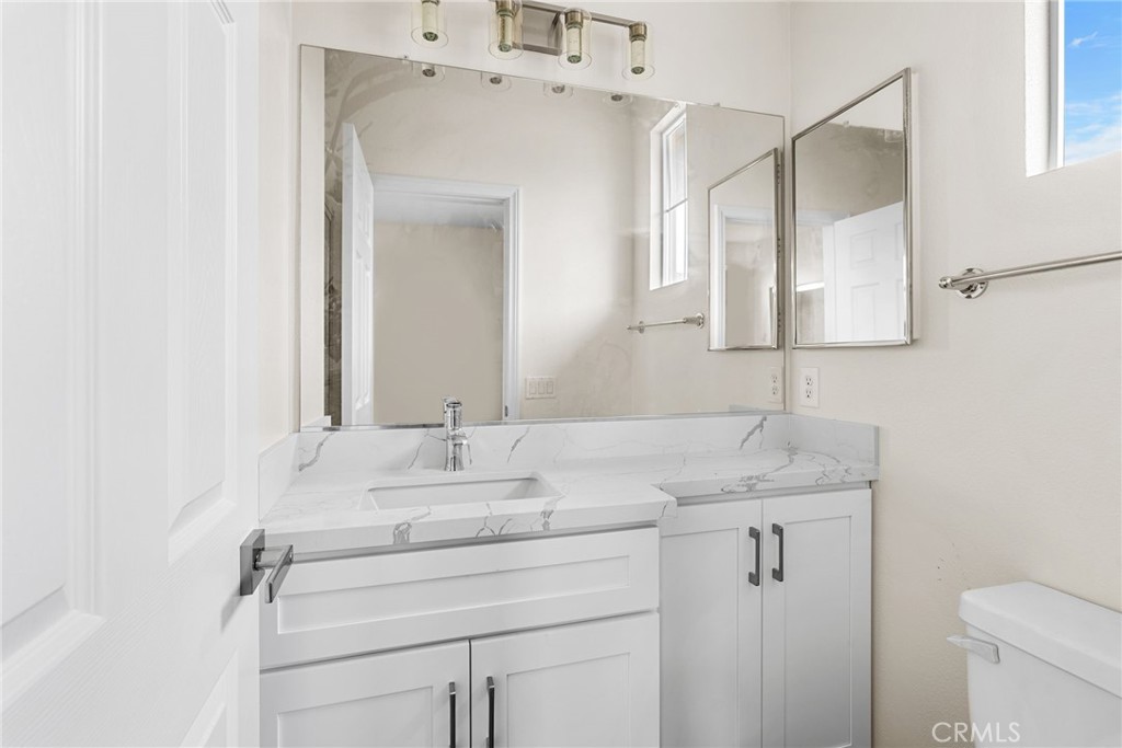 61 Stepping Stone Irvine, CA 92603 - Photo 21 of 24 a bathroom with a granite countertop sink and a mirror