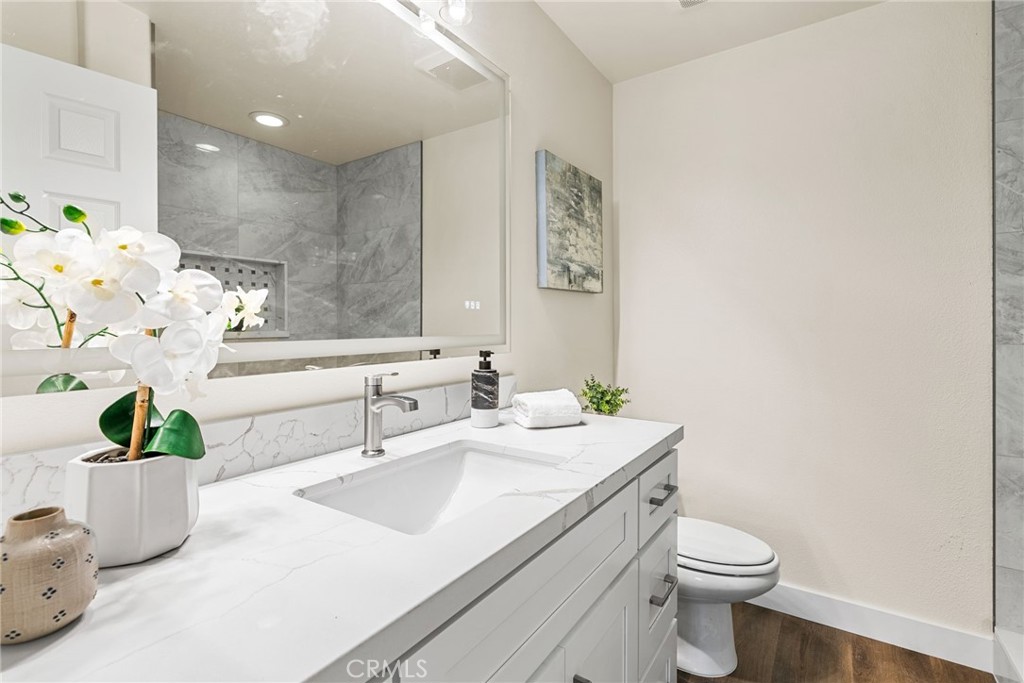 61 Stepping Stone Irvine, CA 92603 - Photo 22 of 24 a bathroom with a sink a toilet and a mirror