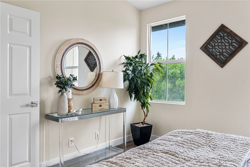 61 Stepping Stone Irvine, CA 92603 - Photo 23 of 24 a view of a bedroom with a bed and a potted plant