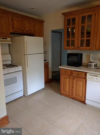 a kitchen with stainless steel appliances granite countertop a stove a refrigerator and a cabinets