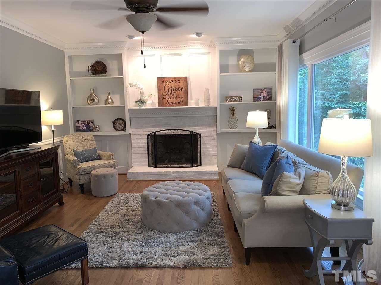 7907 Sandy Bottom Way Raleigh, NC 27613 - Photo 7 of 20 Gas log fireplace & built-ins. Notice the huge picture window!