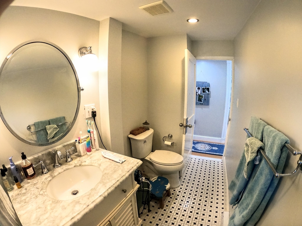 12 Searle Road, Unit 12 Boston, MA 02132 - Photo 18 of 35 a bathroom with a sink toilet and a mirror