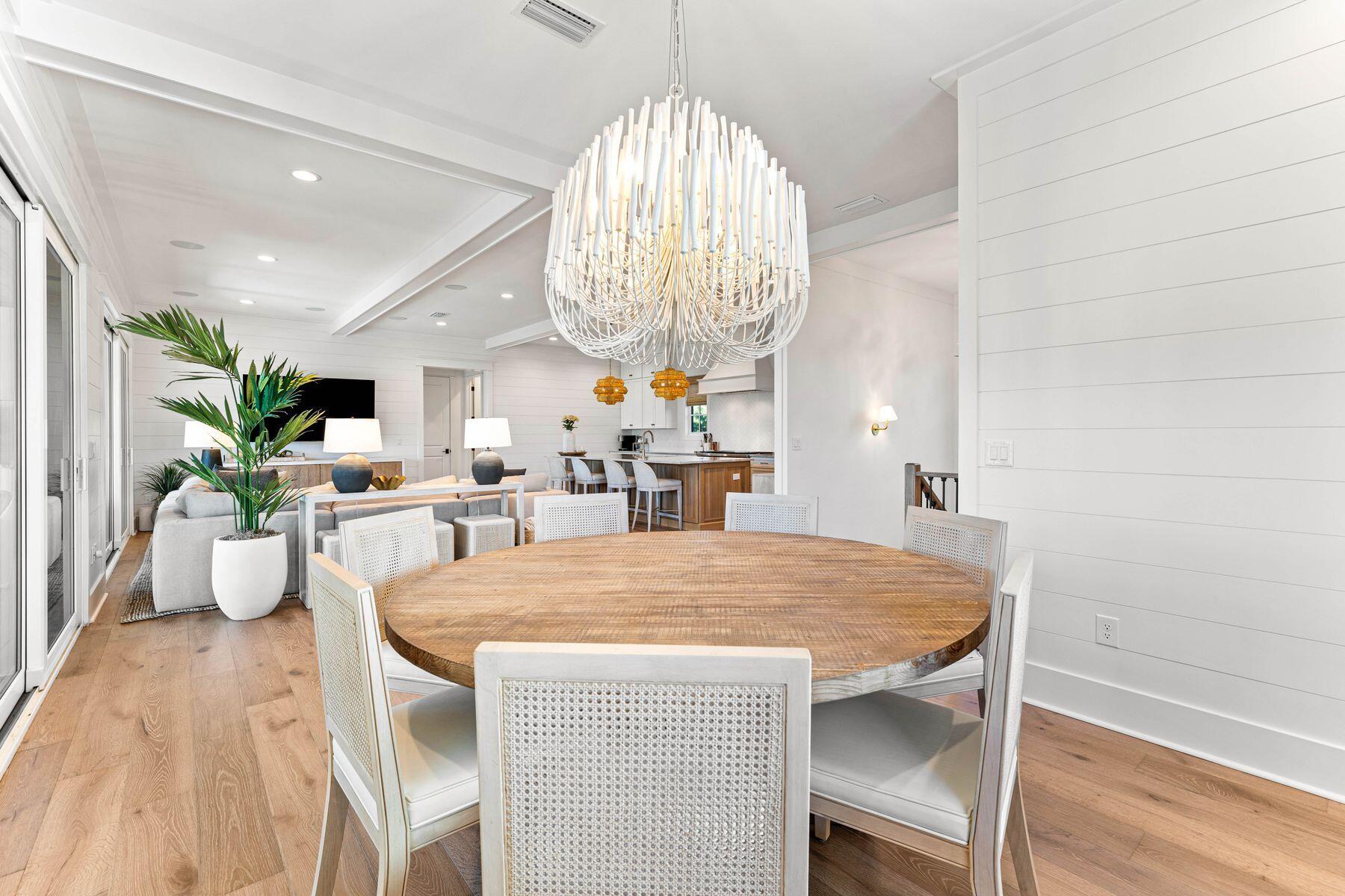 40 Sand Cliffs Dr Inlet Beach Inlet Beach, FL 32461 - Photo 25 of 56 a dining room with wooden floor a chandelier a wooden table and chairs