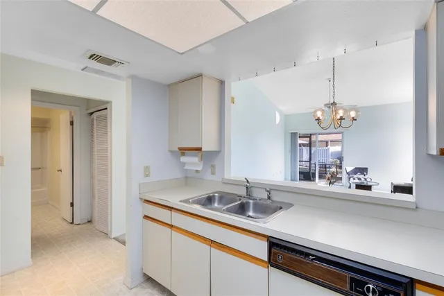 a dining hall with a sink and chandelier
