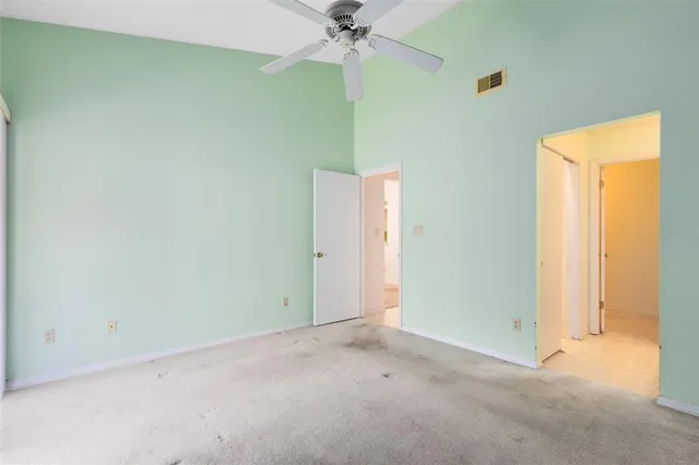a view of a room with a ceiling fan