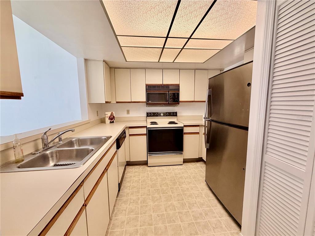 165 Post Way Casselberry, FL 32707 - Photo 2 of 22 a kitchen with a refrigerator a sink and a stove