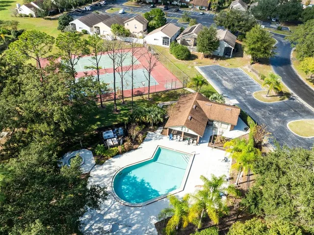 an aerial view of residential house with outdoor space and swimming pool