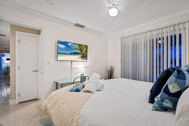 a bedroom with a bed and a painting on the wall