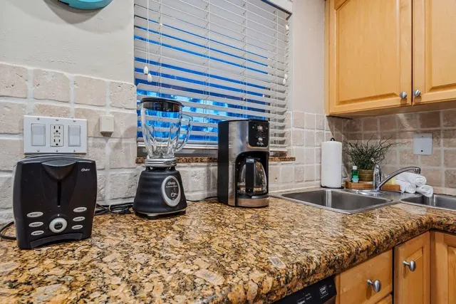 a view of a kitchen with a sink and cabinets