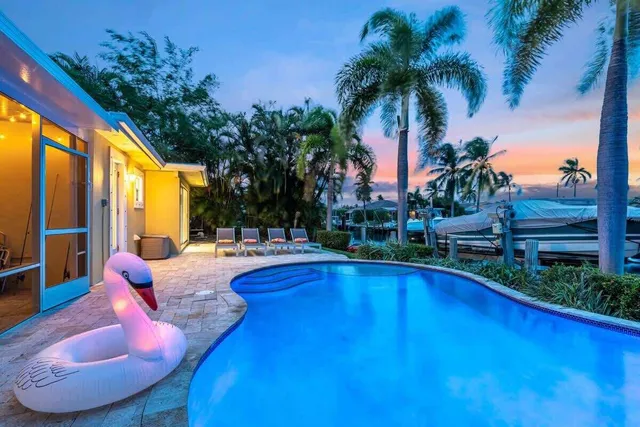 a view of swimming pool with outdoor seating and plants