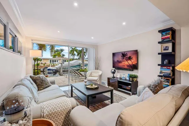 a living room with furniture a rug and a flat screen tv