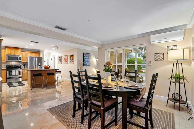a view of a dining room with furniture and a potted plant