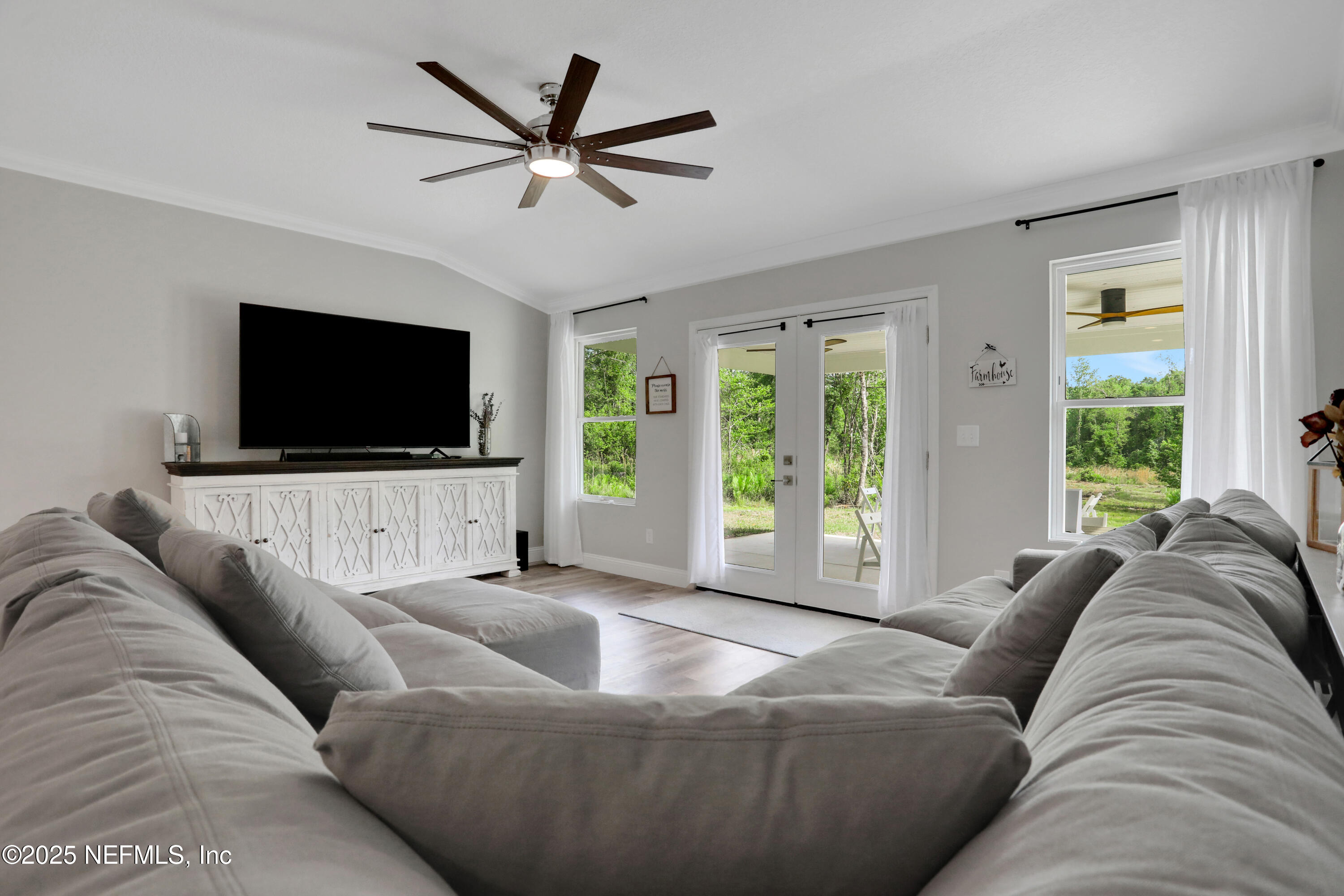 4467 Monroe Smith Road Jacksonville, FL 32210 - Photo 17 of 61 a living room with furniture and a flat screen tv