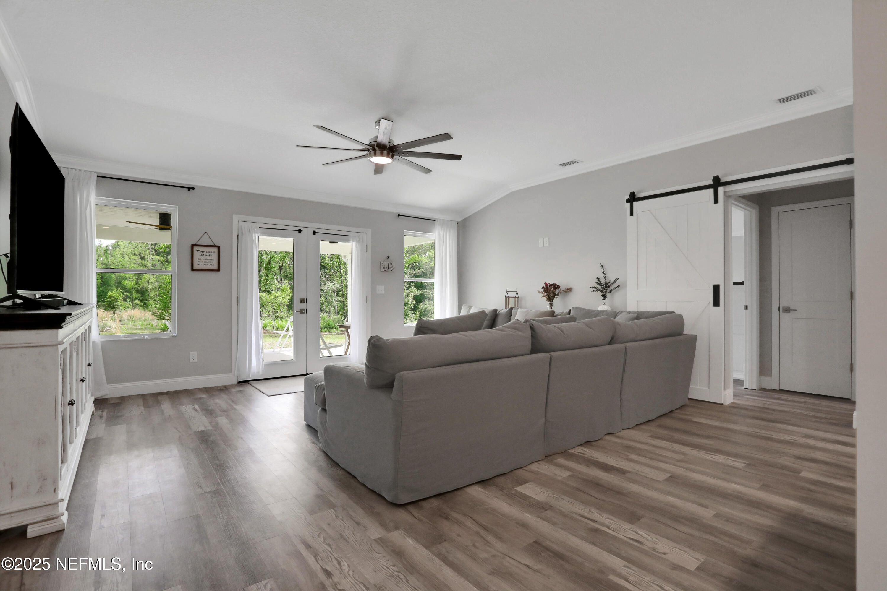 4467 Monroe Smith Road Jacksonville, FL 32210 - Photo 18 of 61 a living room with furniture and a flat screen tv