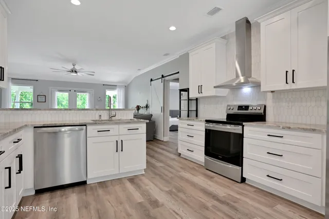 a view of a kitchen with refrigerator and window